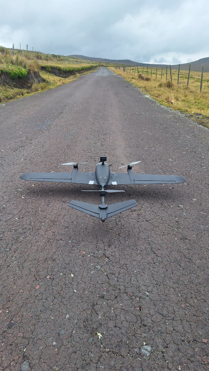 Fixed-wing VTOL prototype positioned on the road, ready for configuration and flight tests.
