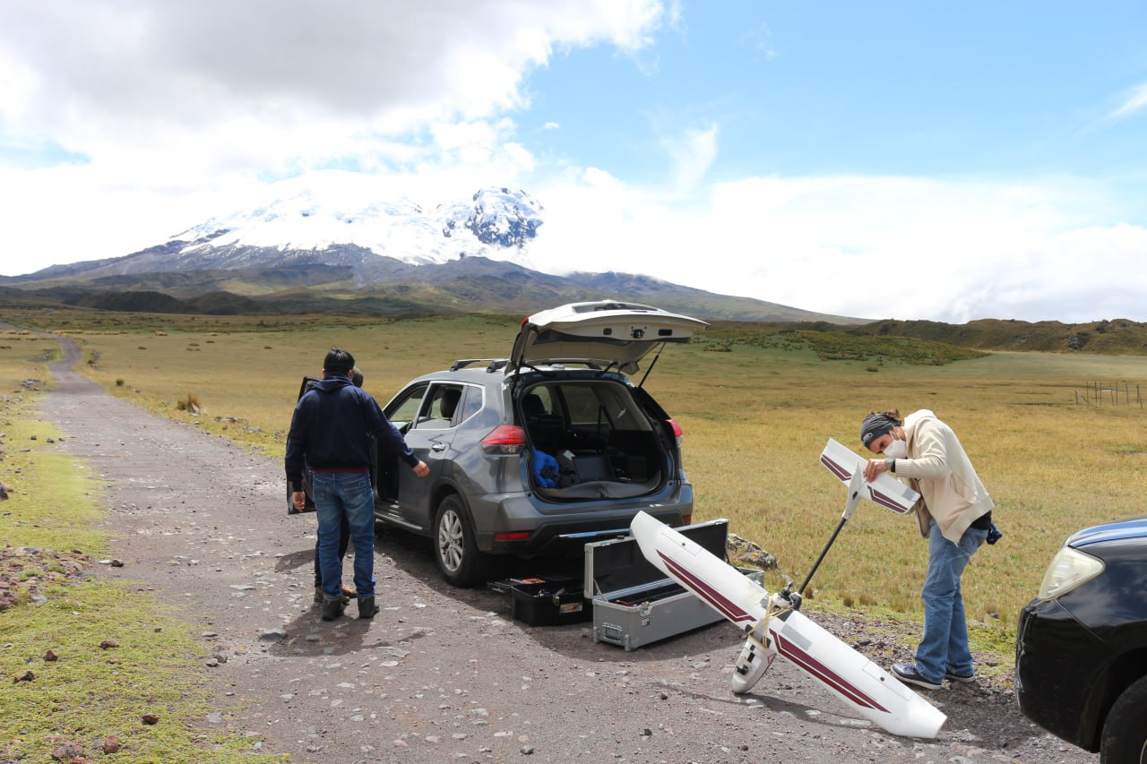 Unloading flight equipment in front of the Antisana volcano.