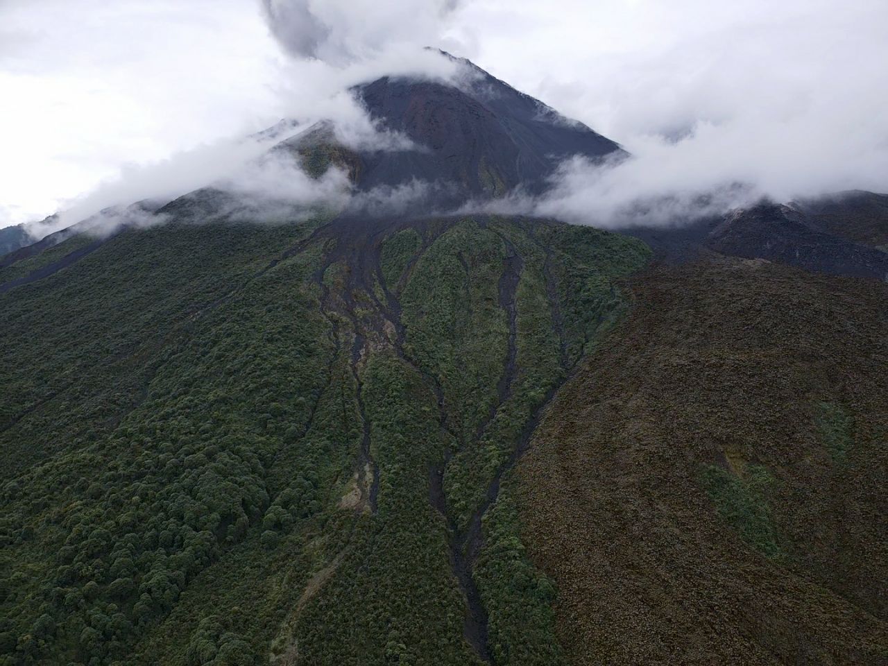 Detailed aerial close-up of the volcanic cone showing recent lava flow furrows.